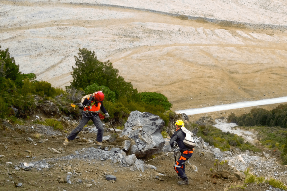 Abseil Access workers moving large rocks.